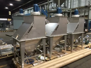 Lineup of three FormPak Bag Break stations inside warehouse