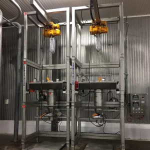 Two FormPak Stainless Steel BagFlo Hoist Trolley machines inside a warehouse